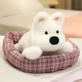 Adorable white plush puppy dog toy lying in a cozy pink checkered pet bed nest - Westie / 20cm