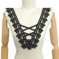 Detailed view of black hollow embroidered lace collar on a mannequin torso - Black