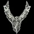 Close-up detail of a white polyester embroidered hollow lace floral neckline applique - White