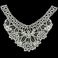 Detail view of white embroidered lace collar with hollow floral and leaf patterns - White