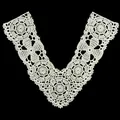 Detailed view of the intricate white floral crochet patterns on a polyester lace collar - White