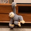Adorable gray long-armed gibbon plush monkey toy hanging on a wooden cabinet shelf - 25cm / Gray