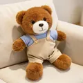Adorable brown teddy bear plush toy wearing a blue sweater and beige overalls - 30 cm / Brown