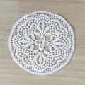 Close-up detail of a white retro water-soluble lace coaster with hollow floral embroidery. - 10cm / 11# (Symmetrical Floral Vintage)