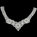 Detailed macro view of white milk silk floral embroidery lace neckline applique - White