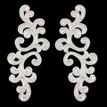 Detailed view of white symmetric floral embroidery lace patches for DIY crafts. - White