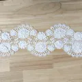 Detail view of white 3D floral lace embroidery trim with intricate hollowed patterns - Flower Border / 10 Yards