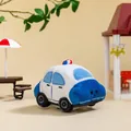 Adorable blue and white cartoon police car plush toy in a miniature outdoor garden setting - Blue Police Car / 11cm
