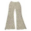 Detailed view of cream crochet lace flared trousers with intricate floral embroidery - One Size / Bottoms