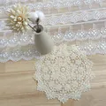 Macro view of intricate beige water-soluble lace embroidery on round table mat - 15cm / Platycodon Style
