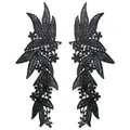 Detailed view of symmetrical black polyester lace floral embroidery appliques. - Black