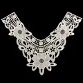 Detailed macro view of intricate white floral embroidery on a water-soluble lace collar - White