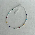 Close-up view of a s925 silver bracelet featuring vibrant colorful beads and a heart charm - 925 Silver / Multicolor Beads