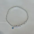 Close-up of S925 silver beaded bracelet with blue gem charm and shell bead detail - Marine Starfish Design (B6037)