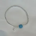Detailed view of S925 silver beaded elastic bracelet with blue stone and starfish charm - Starfish Smooth Tube Design (B6038)