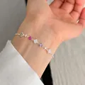 Close-up of a dainty S925 silver bracelet with five colorful stone flower charms. - Colorful Clover Style (B6140) / Silver