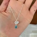 Detailed macro view of 925 sterling silver necklace featuring a light blue teardrop gemstone - Blue Water Drop Flower Cluster Necklace (N1408)