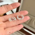 Detailed close-up view of elegant s925 silver lace flower earrings held on fingers for scale - Flower Rhinestone Earrings (E8466)