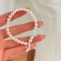 Detailed view of pearl bracelet with light blue crystal and silver bird charm - 925 Silver / Blue Stone Bird Charm Style (B6800)