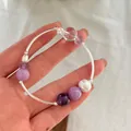 Close-up detail of 925 sterling silver curved tube bracelet with crystals and pearl - 925 Silver / Purple Crystal Stone Style (B3149)