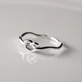 Close-up of minimalist sterling silver knot ring with adjustable open band design - Simple Knot Design (J0022)