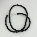 Macro detail view of black agate beaded necklace with s925 sterling silver clasp - 925 Silver / 4mm