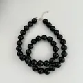Detailed macro view of polished black agate beads on a S925 sterling silver chain - 925 Silver / 10mm