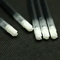 Detailed macro shot of 100mm black gel pen refills with white plastic precision tips - Red