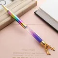 Creative ballpoint pen with rainbow metal barrel, purple liquid glitter, and gold reindeer head. - Iridescent