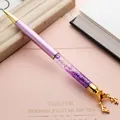 Elegant purple quicksand ballpoint pen featuring a golden reindeer topper design. - Purple