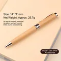 Elegant wooden ballpoint pen with silver metal accents on a cream notebook - White Wood Silver Accessories