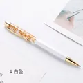 Elegant white ballpoint pen with decorative gold leaf flakes in a clear barrel - White