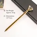 Luxurious gold metal ballpoint pen with a large sparkling crystal diamond decorative top - Gold
