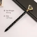 Creative black polka dot ballpoint pen with large crystal diamond topper and gold accents - Black with White Dots