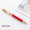 Elegant red metal ballpoint pen featuring luxury gold leaf flakes suspended in oil - Red