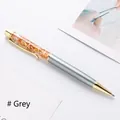 Elegant grey metallic ballpoint pen with gold foil accents in clear top oil barrel - Gray