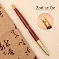Stylo à bille de luxe en laiton et bois de rose avec décoration de boeuf du zodiaque - Dalbergia-Boeuf