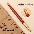 Handcrafted rosewood and brass rollerball pen featuring an intricate monkey zodiac design - Dalbergia-Monkey