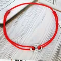 Detailed view of a minimalist red adjustable cord bracelet with a silver pig nose charm - Pig Nose Woven Bracelet / Red-Silver Plated
