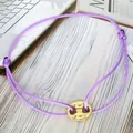 Detailed view of the purple adjustable rope bracelet featuring a gold pig nose charm - Pig Nose Woven Bracelet / Purple-Gold Plated-Textured