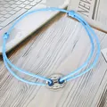 Detail view of light blue braided friendship bracelet with silver pig nose buckle - Pig Nose Woven Bracelet / Sky Blue-Silver Plated