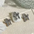 Elegant silver bow-shaped nail art charms with sparkly zircon stones for luxury manicure - 13.1x10.5mm (1 Piece/Pack)