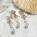 Elegant gold bow nail art charm with zircon stones and pearl tassel dangles, size 36.6x6mm - Bow Pearl Tassel (G626)