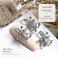 Luxury silver bow-shaped nail art charm with clear rectangular crystal detail G685 - Silver Twisted Bow (G685#)