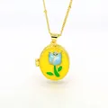 Detailed view of an 18k gold oval locket necklace featuring a blue enamel tulip design - Bright Yellow Background - Blue Tulip Style (C1)