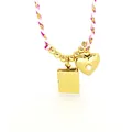 Macro detail of a gold heart and book locket pendant necklace with pink braided cord. - Heart and Book Locket with Rope Chain