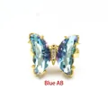Detailansicht eines schimmernden blauen Kristall-Schmetterlingsrings mit Goldbeschichtung - Einstellbar Offen / Blau AB