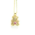 Detailed macro shot of a gold teddy bear pendant featuring pink heart zirconia stones - White Bear with Pink Heart