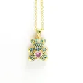 Close-up of golden teddy bear necklace with blue pavé zircons and a pink heart crystal - Blue Bear with Pink Heart