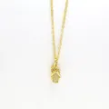 Close-up of a gold-tone necklace with a sparkling pavé flip-flop sandal pendant - Slipper Style